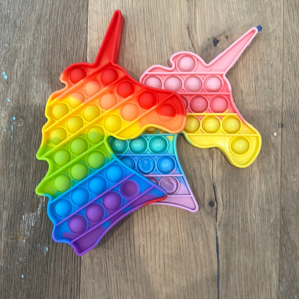 Two rainbow unicorn pop it’s . One pastel and one regular